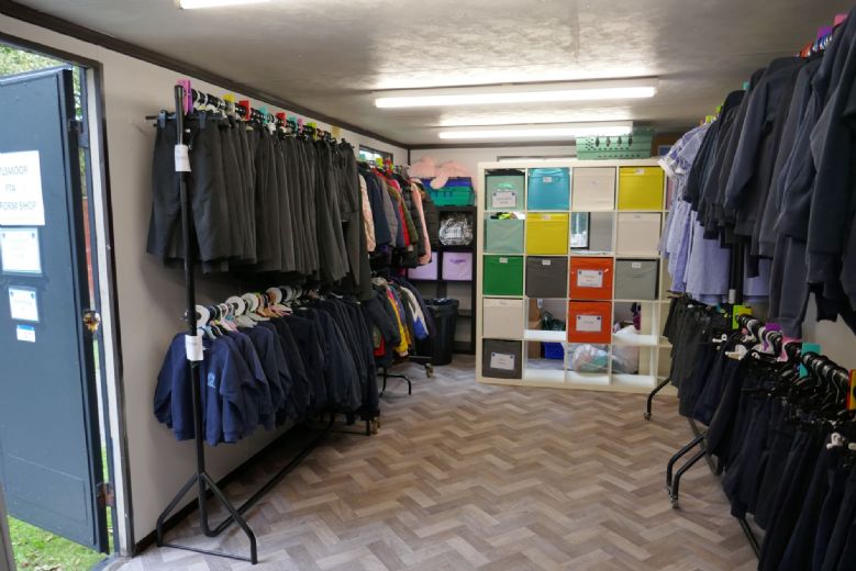 Inside PTA shop, rails of clothes and colourful drawers