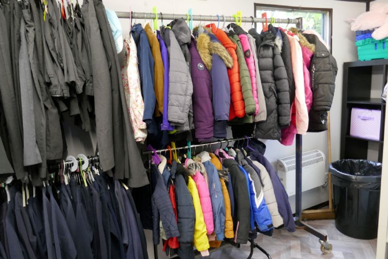 Inside the PTA shop, rails of winter coats