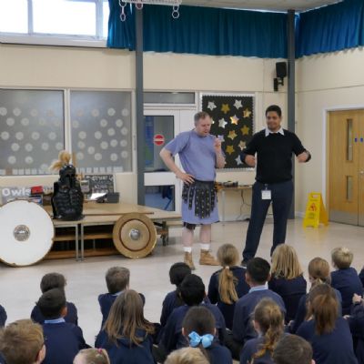 Ancient Greek presenter with our teacher and the pupils are in the foreground.