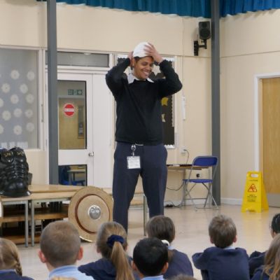 Our teacher and the pupils are in the foreground.