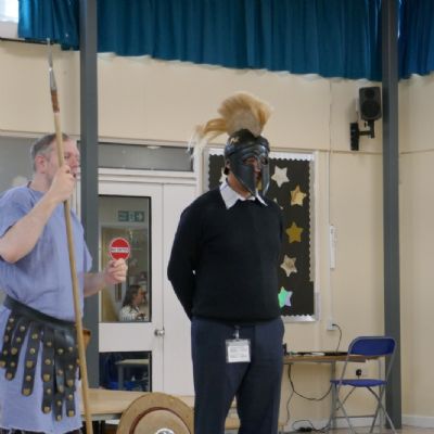 Ancient Greek presenter and our teacher in a helmet.